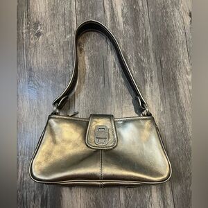 The Sak Metallic Gold Leather Baguette Mini Shoulder Bag with Turn Lock Closure